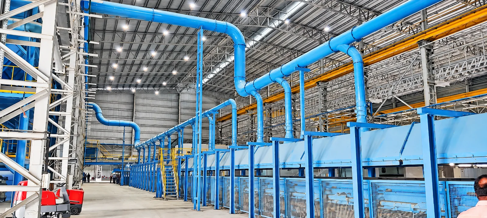 Aquasub Engineering Unit V Foundry project photograph 10: Completed factory installation showing the integrated ducting, conveyors and production equipment.